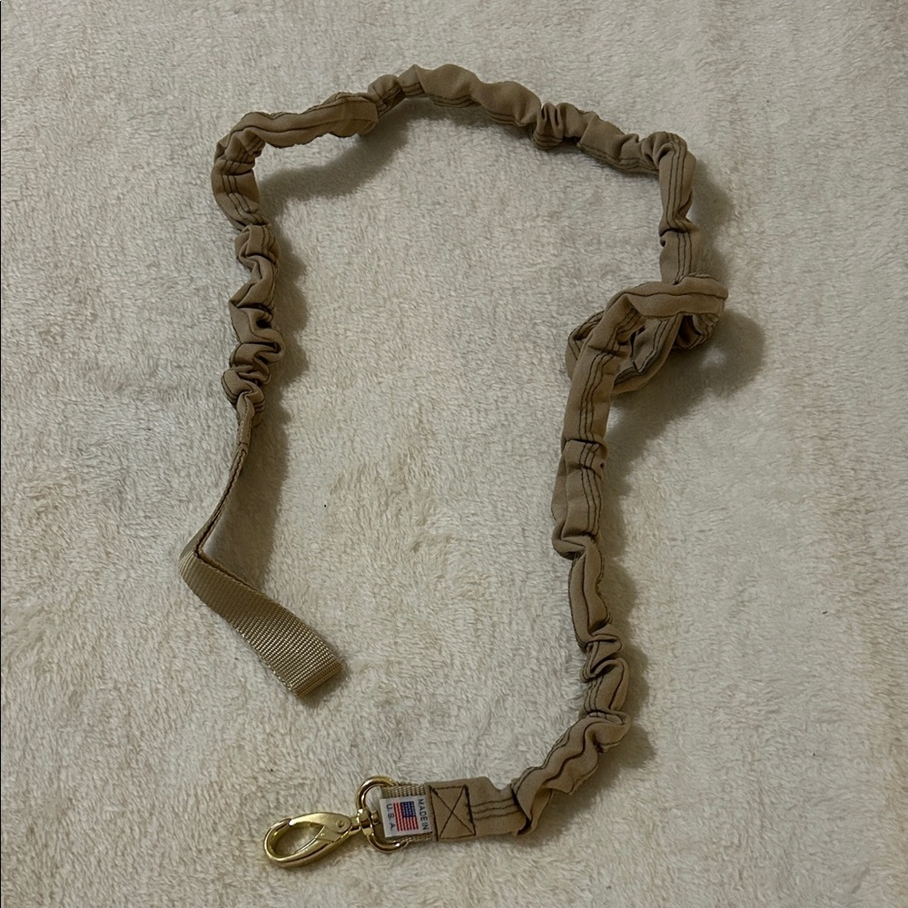 Dog Leash:  tan, tethered dog leash with gold clip.  Product was made in the USA